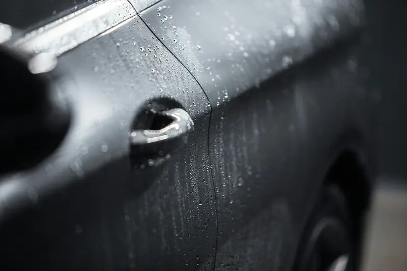 Water droplets on dark car paint
