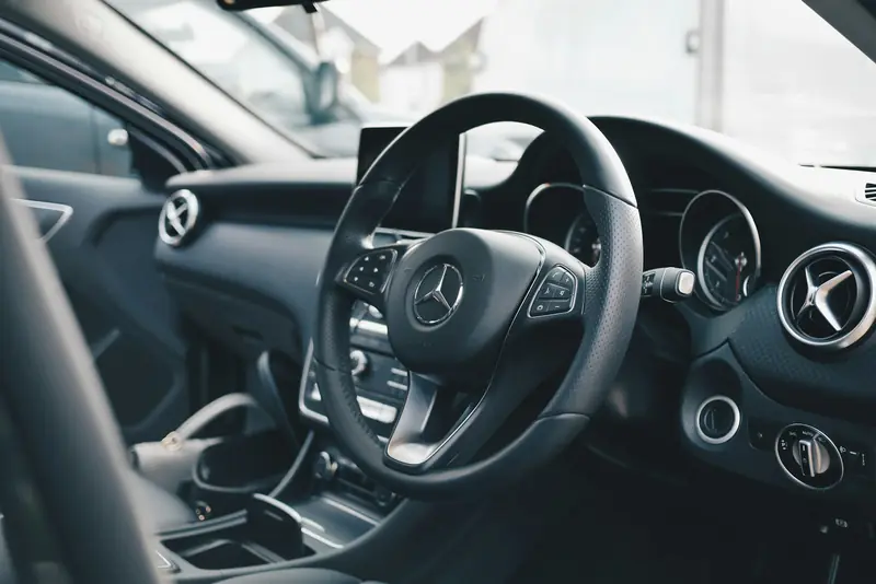 Clean leather interior with steering wheel and dashboard